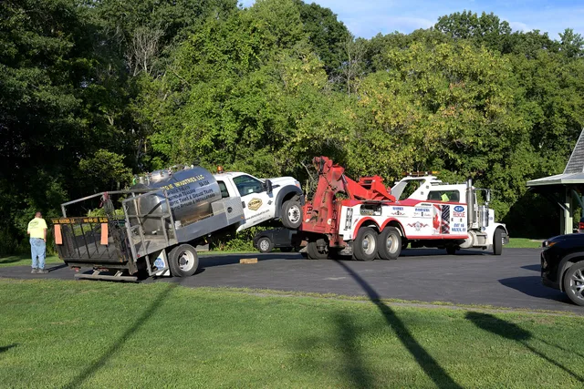 A broken-down portable toilet service truck gets towed in Voorheesville, NY. How to price portable restroom rental jobs from the drive, not the unit
